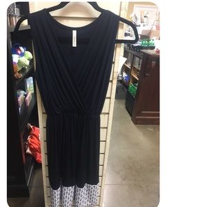 BRAND NEW navy dress with detailing on the bottom.